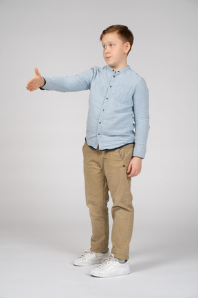 Side view of a boy giving a hand for shake