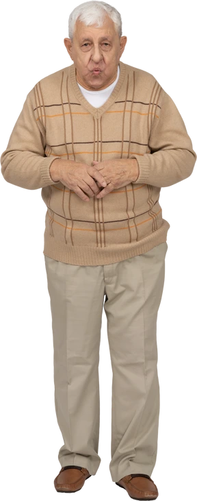 Front view of an old man in casual clothes looking at camera