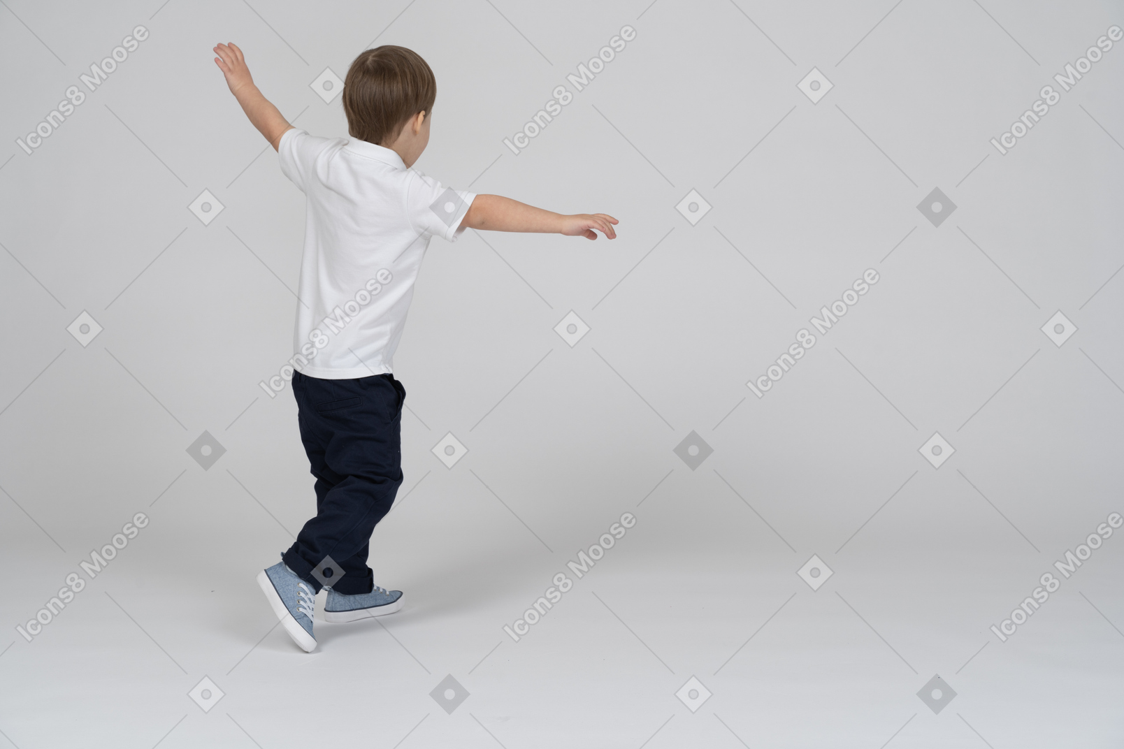Little boy running and pretending to be an airplane