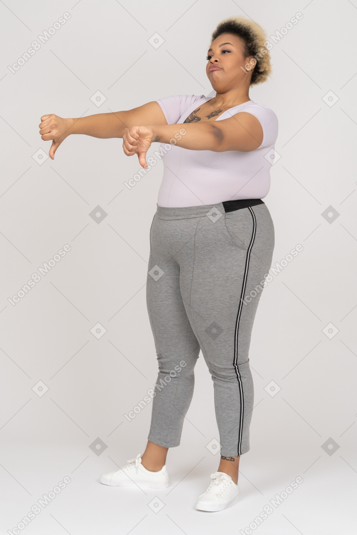 Disappointed afro female giving thumbs down with both fingers