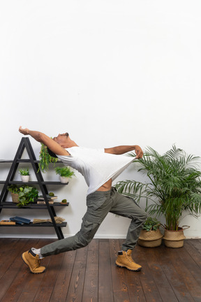 Handsome athletic man posing on the background of the apartment