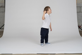 Side view of a boy calling out to the right
