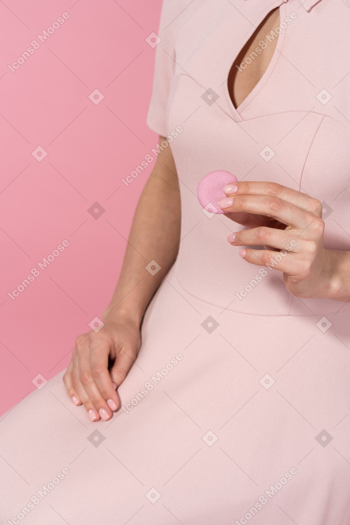 Holding a pink macaron