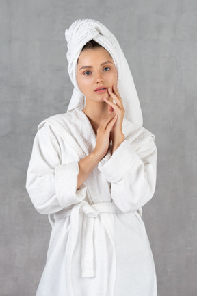 Woman in bathrobe holding her hands together
