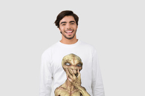 A man wearing a long sleeved shirt with a picture of an alien on it