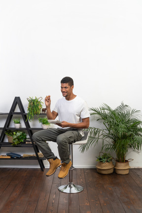 Good looking young man sitting on a chair