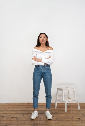 Young woman standing with arms crossed