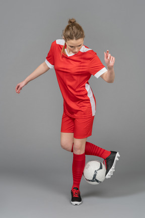 A female football player driving a ball