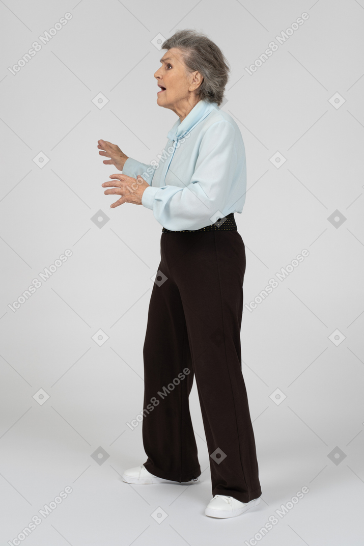 Side view of an old woman scared in motion