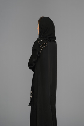 Muslim woman standing backwards