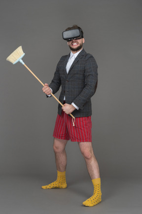 Man in vr headset with a broom