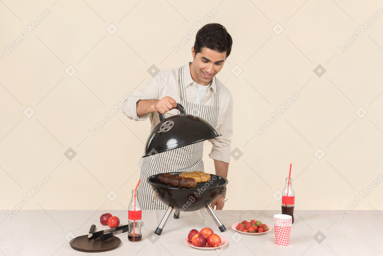 Young caucasian man opening a grill