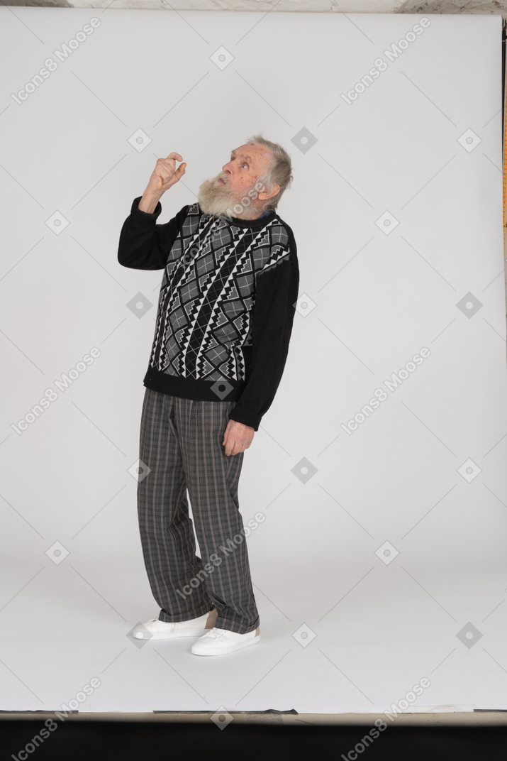 Old man looking up with raised arm