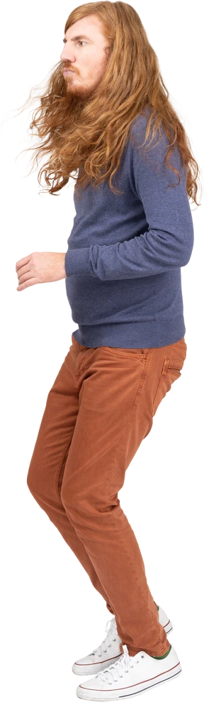 Side view of a young man in casual clothes jumping