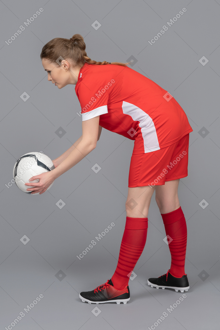 A football player is about to pass the ball