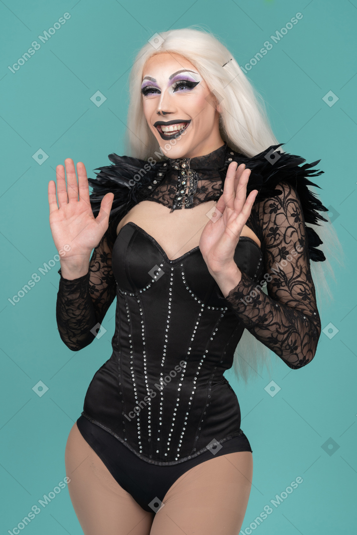 Excited smiling drag queen raised palms for clapping