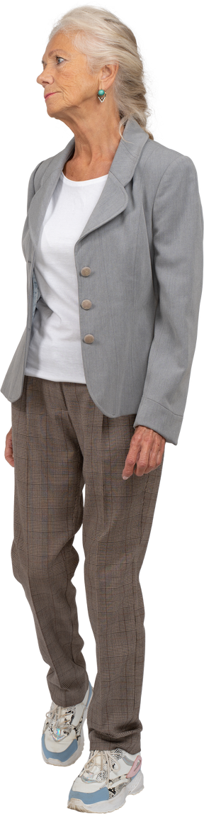 Front view of an old lady in suit walking forward
