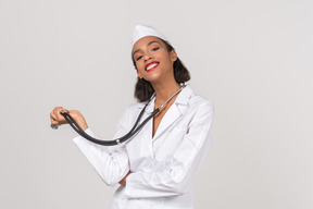 Attractive young female doctor holding a stethoscope