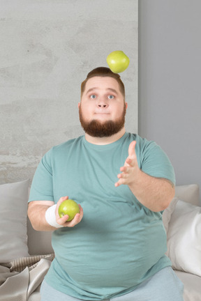 A man juggling apples