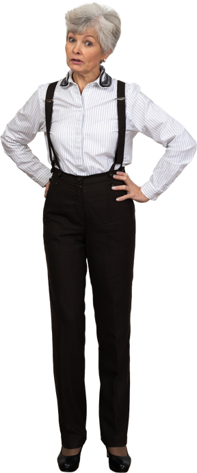 Full-length of an old questioning  female in suspenders putting hands on hips