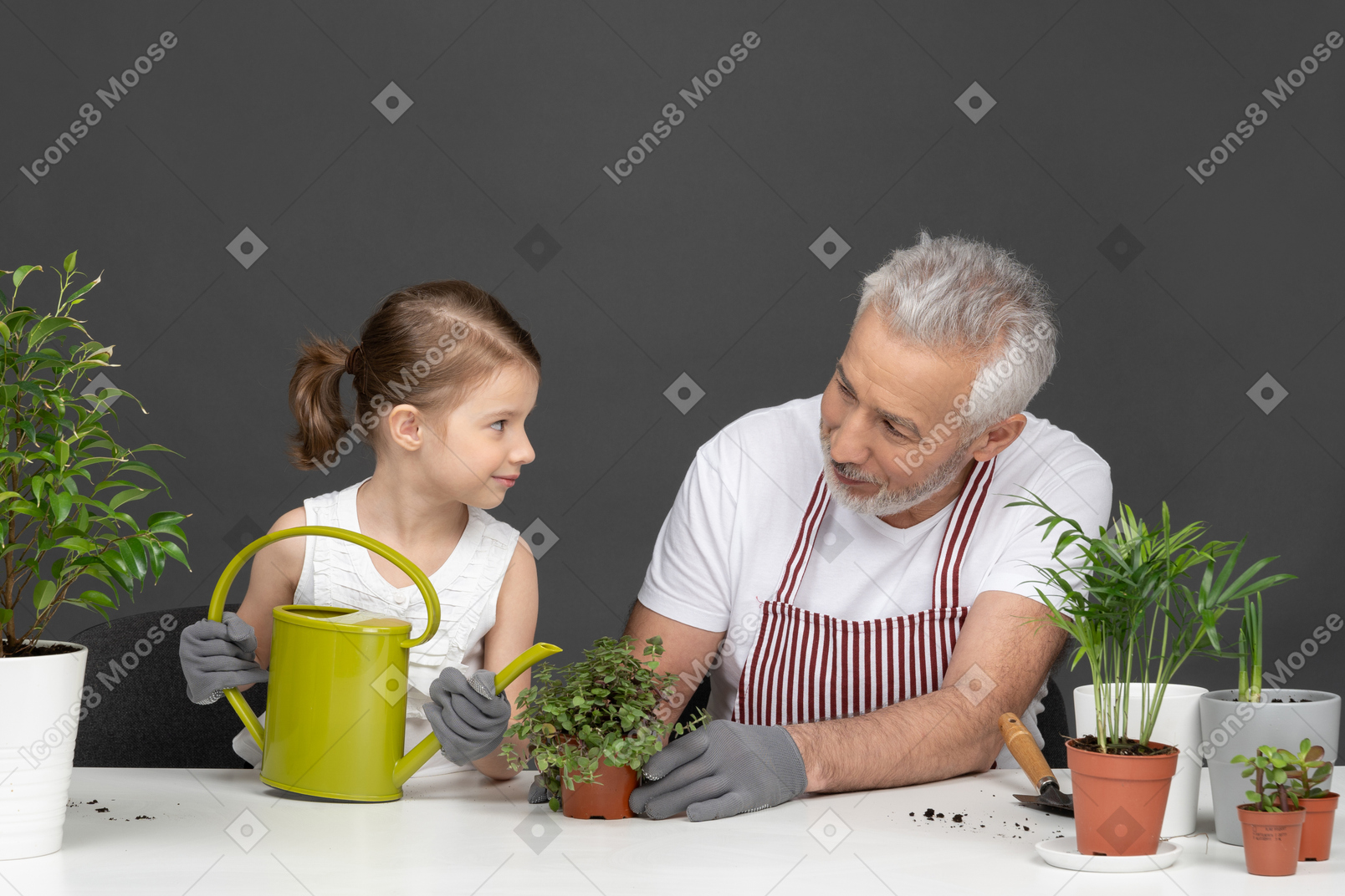 Niña y hombre maduro de jardinería