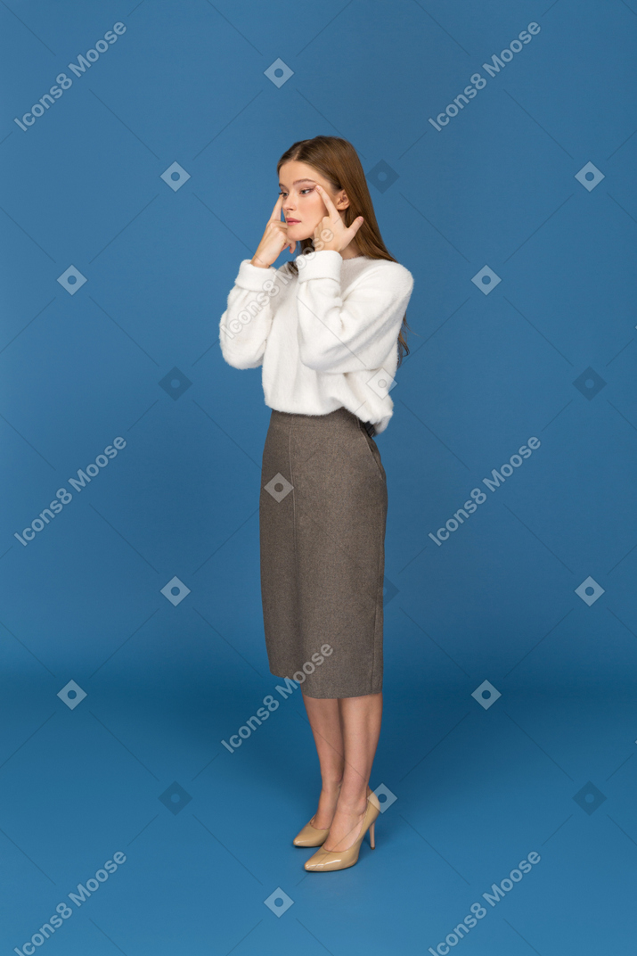 Young businesswoman stretching eyes