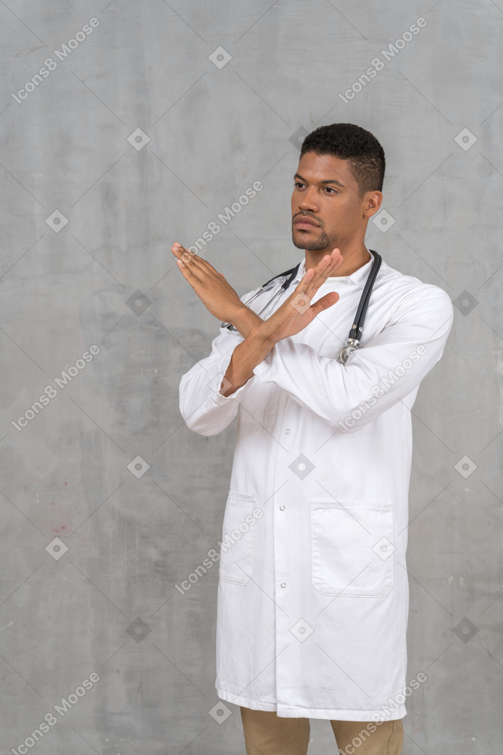 Male doctor making a stop gesture
