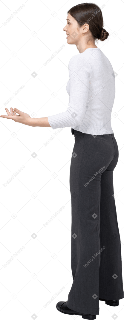 Vue latérale d'une jeune femme en vêtements décontractés faisant des gestes