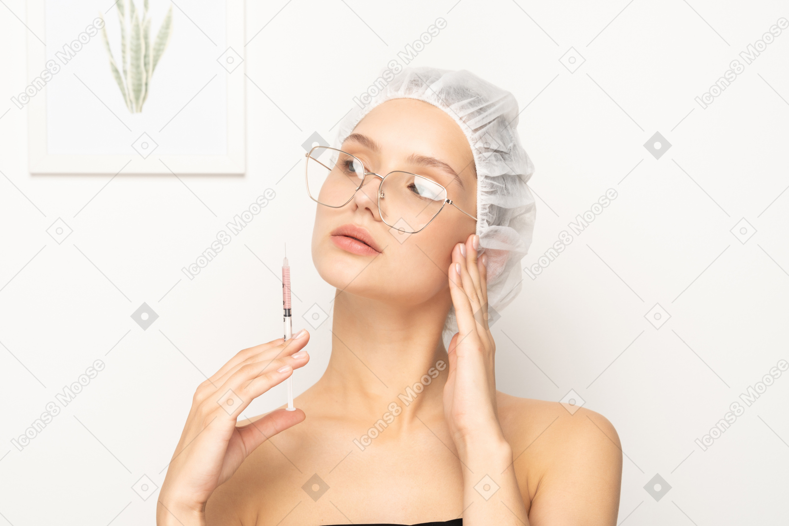 Young woman in glasses holding syringe