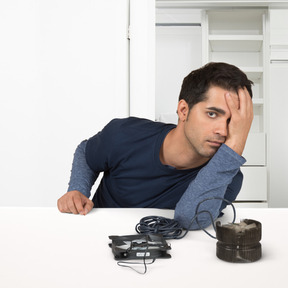 A man sitting at a table with computer details