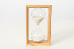 Wooden hourglass on a white background