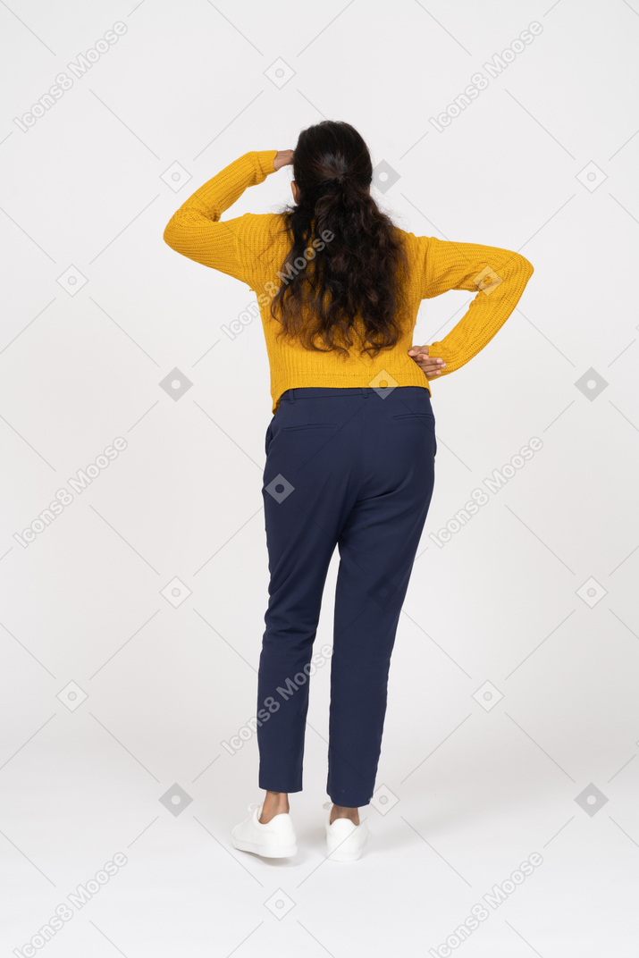 Rear view of a girl in casual clothes looking for someone