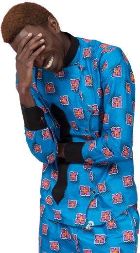 Black man in blue pajamas laughing