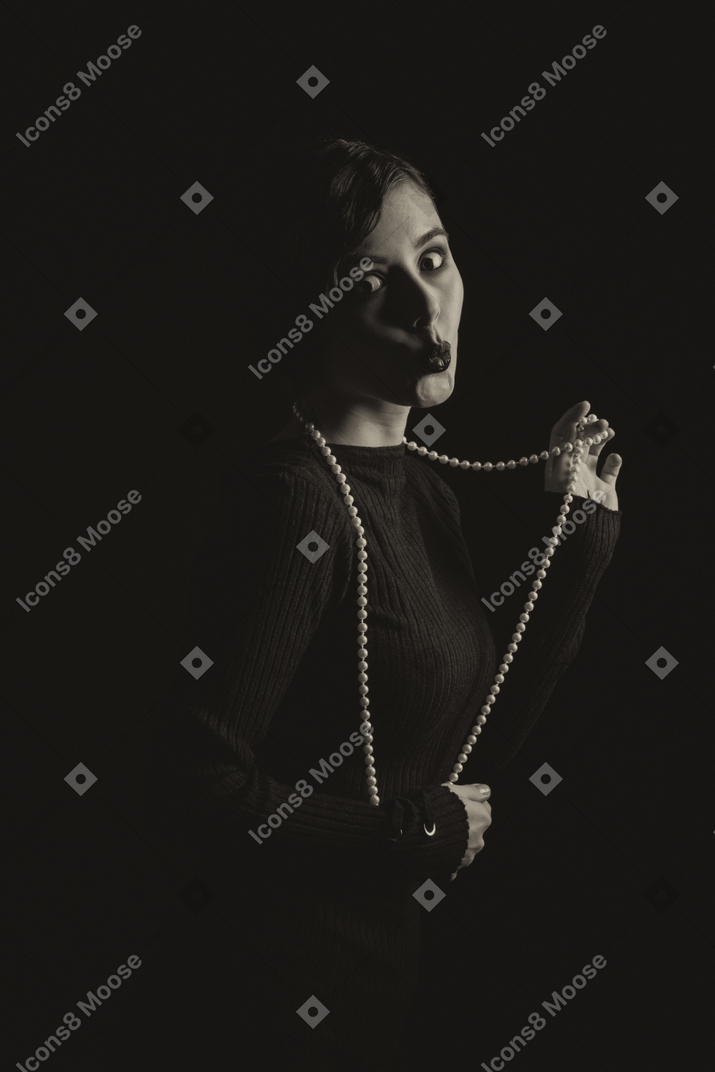 Intriguing woman with a string of beads