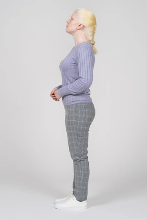 Side view of a young woman looking up with her hands folded