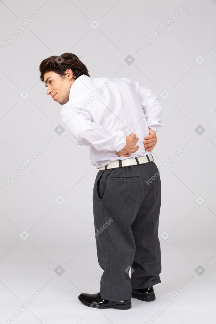 Rear view of businessman groaning with back pain