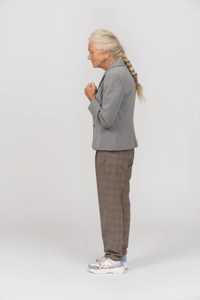 Old lady in suit standing in profile