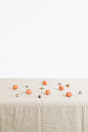 Chicken and quail eggs on a white tablecloth