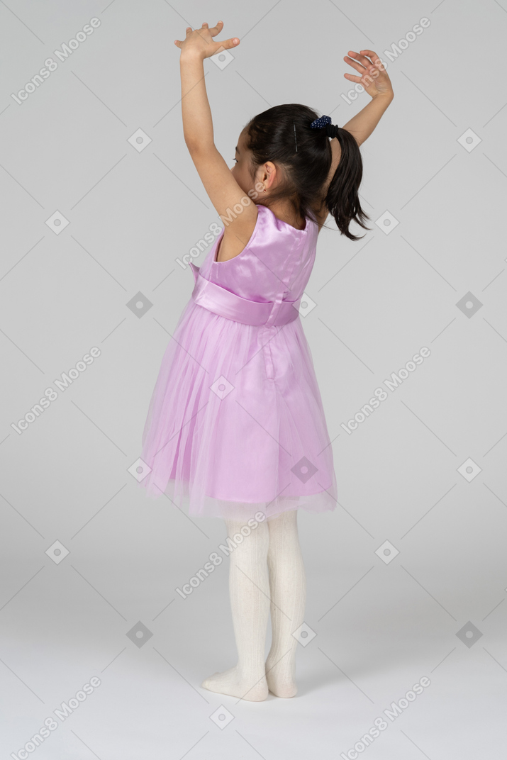 Girl in pink dress showing something huge with her hands