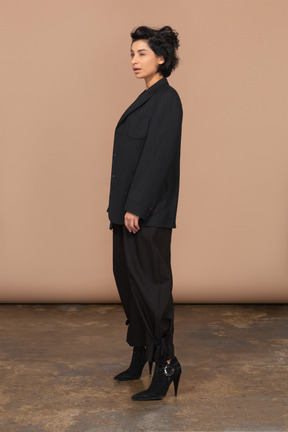 Woman standing in black suit and heels