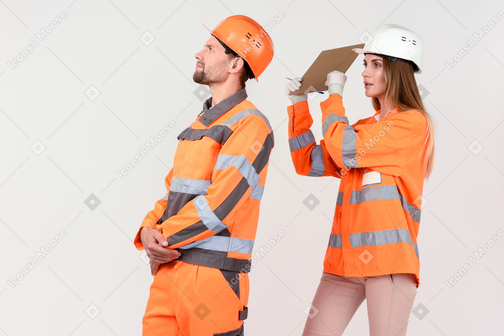 Female street worker is going to hit male street worker with file