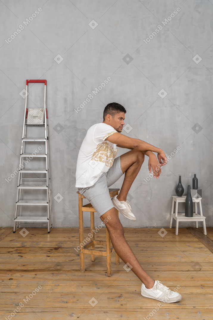 Side view of thinking man sitting on chair