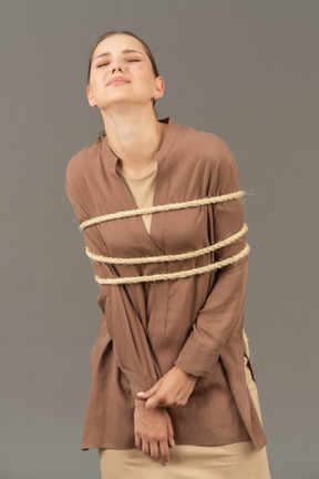 Young woman tied up painfully