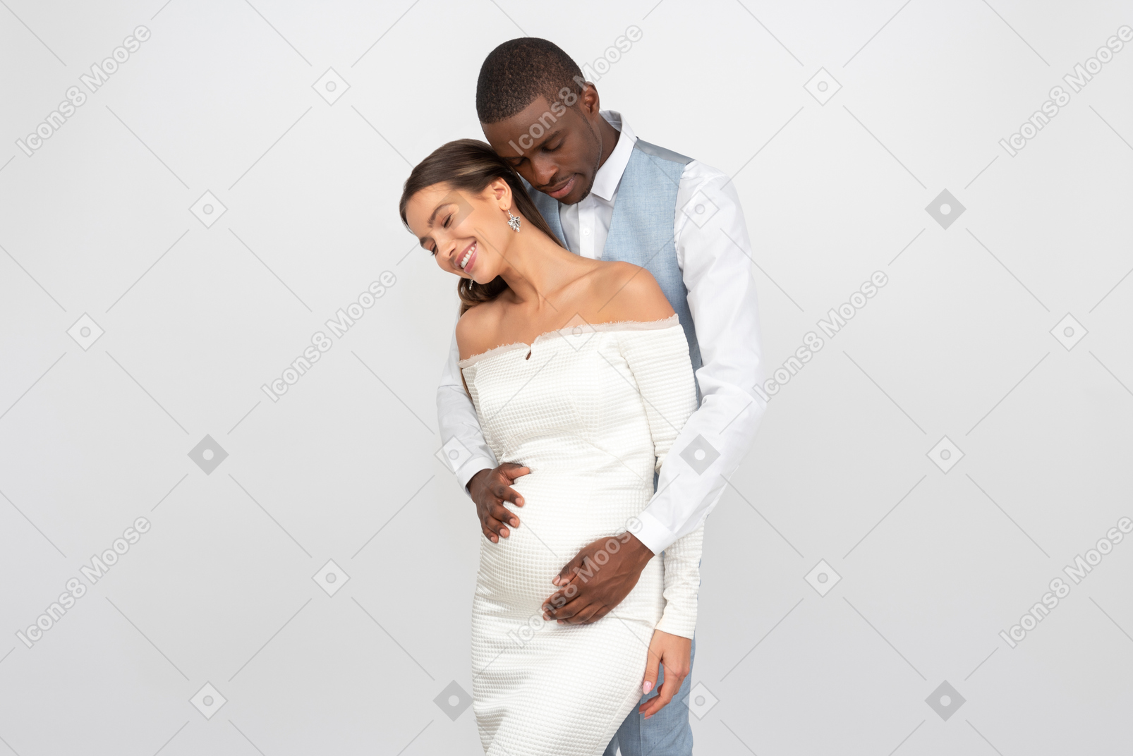 Handsome groom hugging his pregnant bride