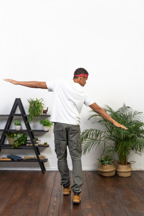 Good looking young man posing on the background of the apartment