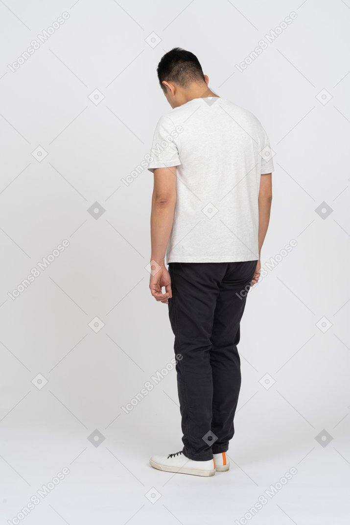 Back view of a man in casual clothes bending head down