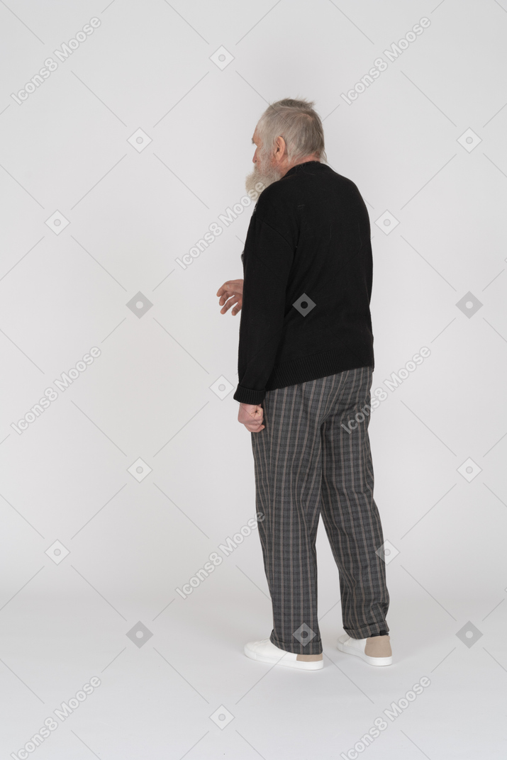 Back view of an old man reaching out with his hand
