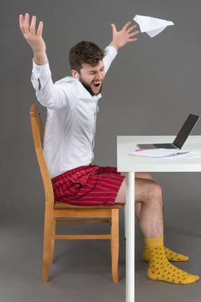 Depressed young man working remotely