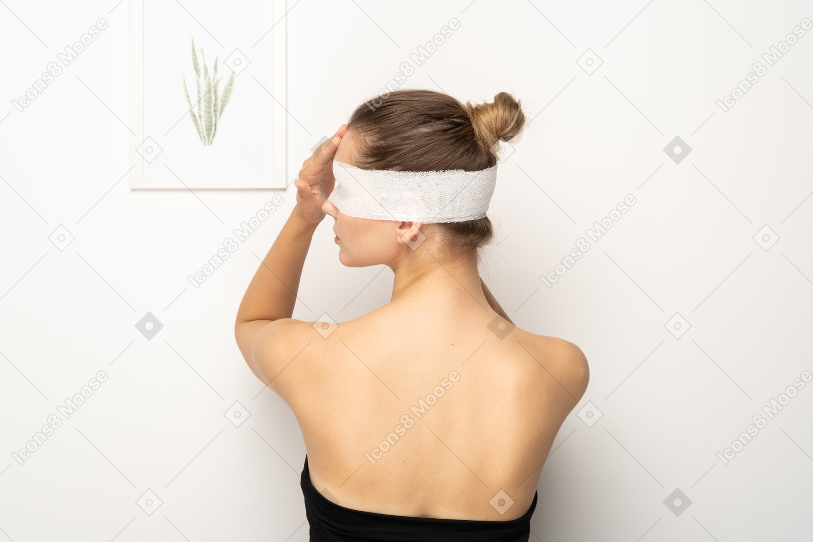 Back view of a woman with bandage over her eyes