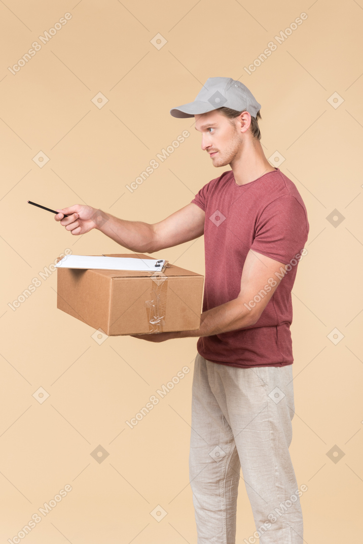 Delivery guy holding box and handling a pen